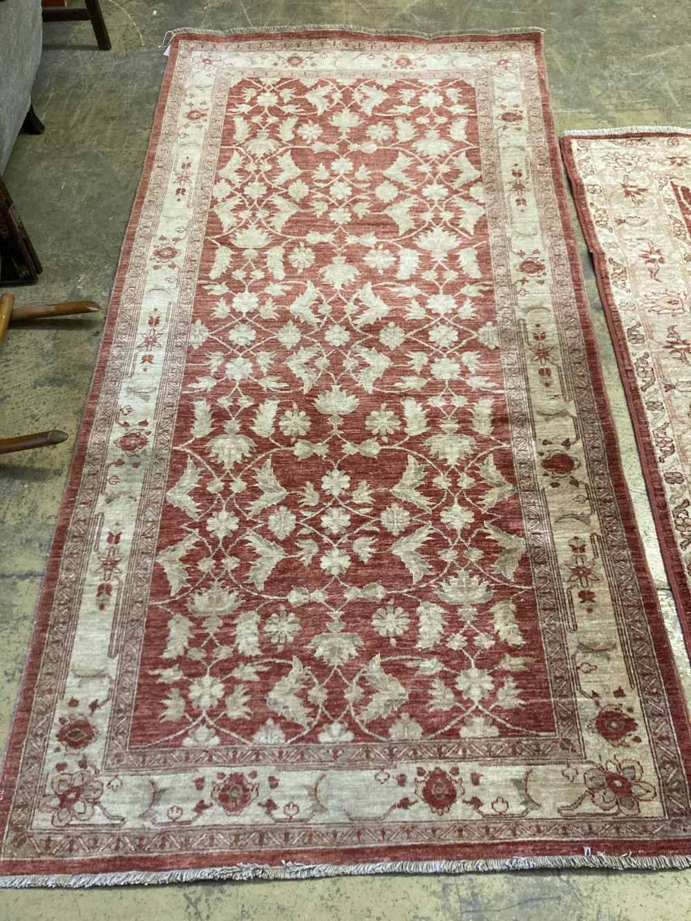 A near pair of Ziegler style red ground rugs, larger 255 x 125cm